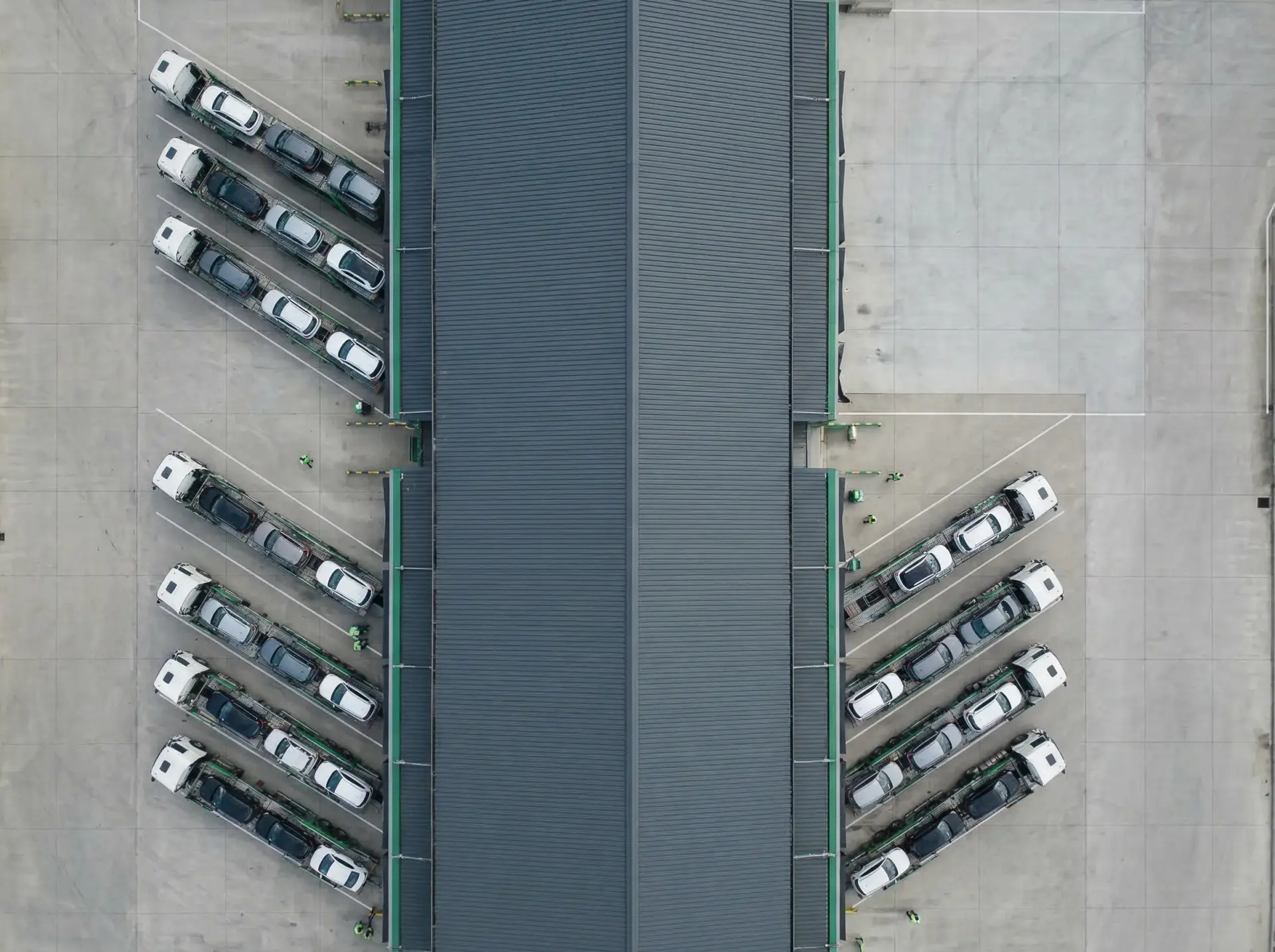 Vista aérea de camiones portacoches cargados en una terminal logística